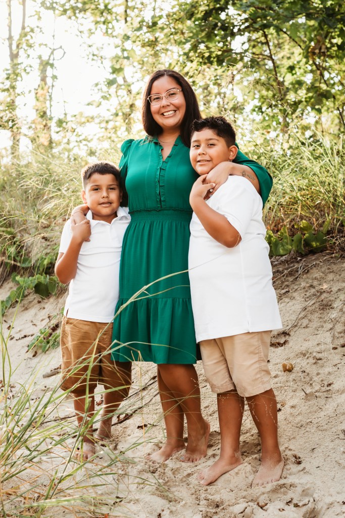 Mom and child hugging during sunset beach photo session in Southwest Michigan