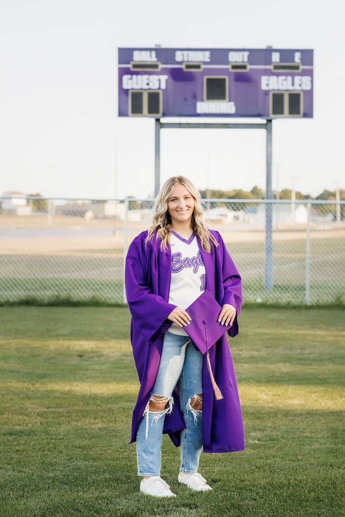 Schoolcraft Michigan senior picture cap and gown softball field with jersey underneat