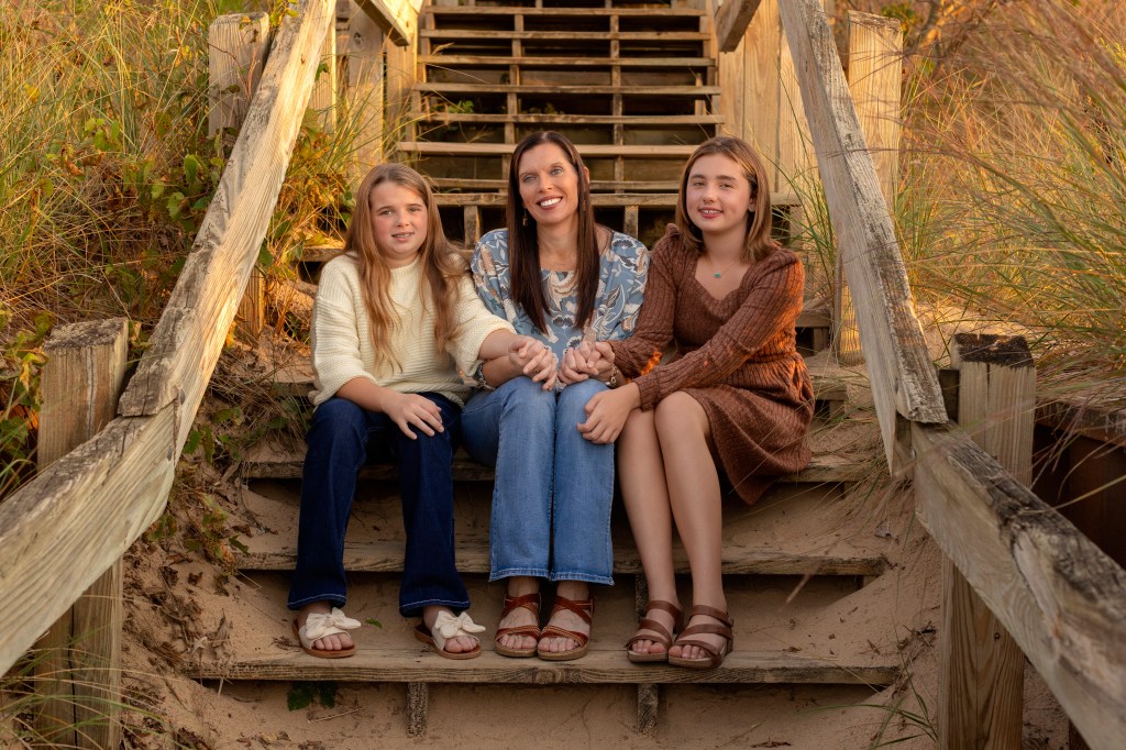 Mother with her children laughing in field during spring photo session Southwest Michigan