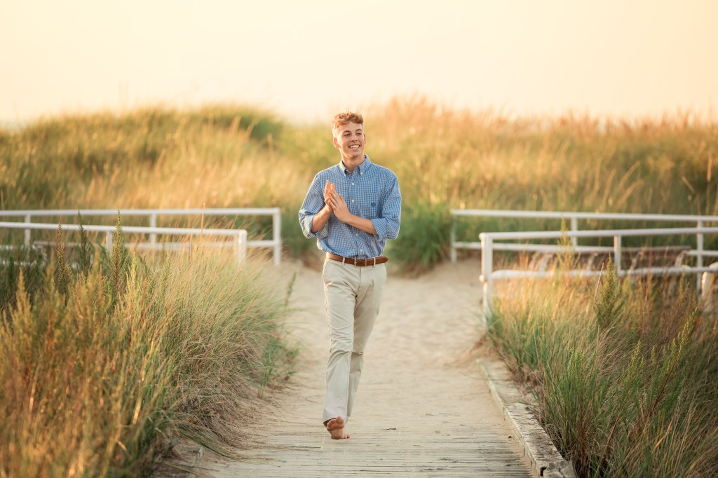 senior walking down beach boardwalk berrien county