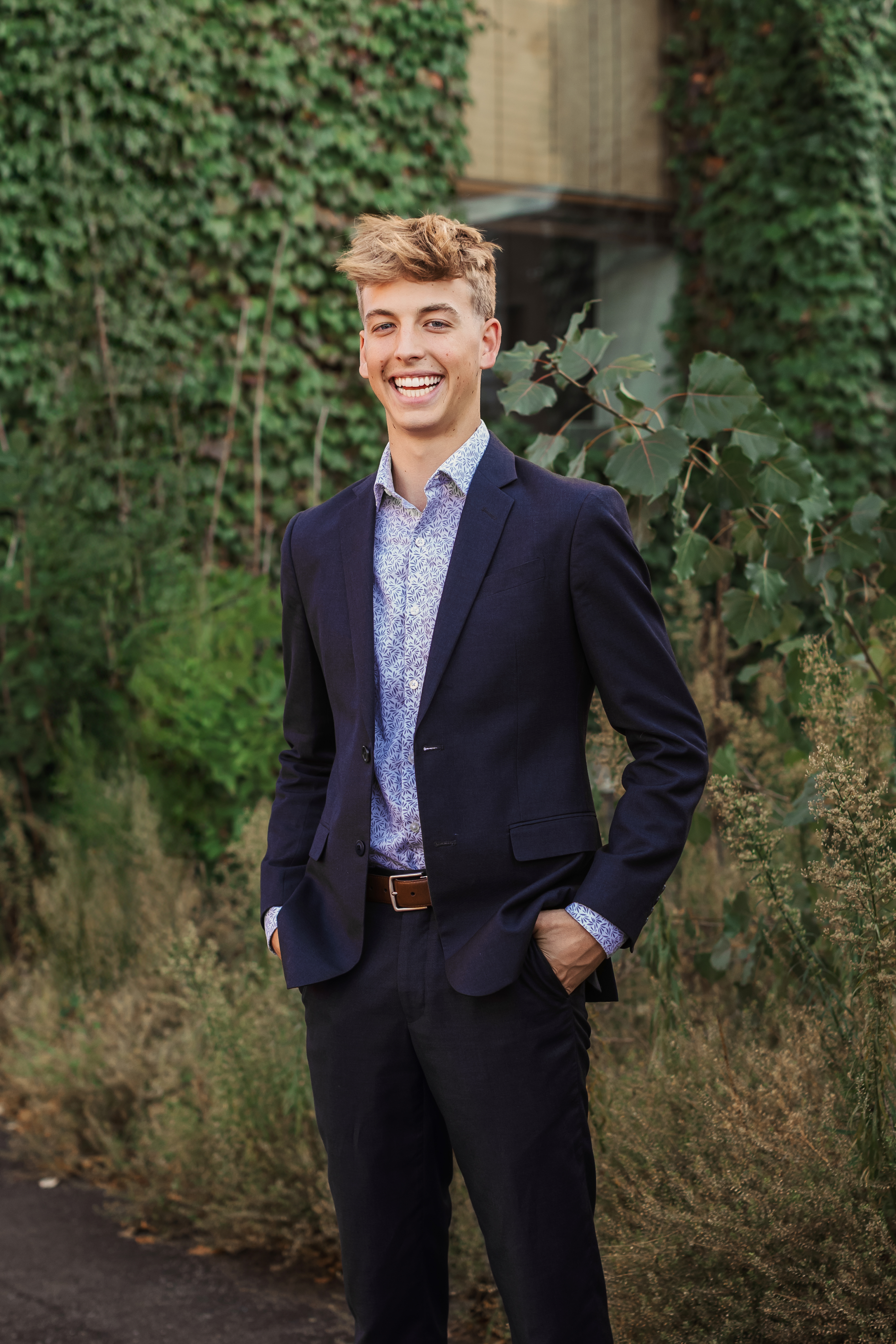 senior in front of vine covered buildings