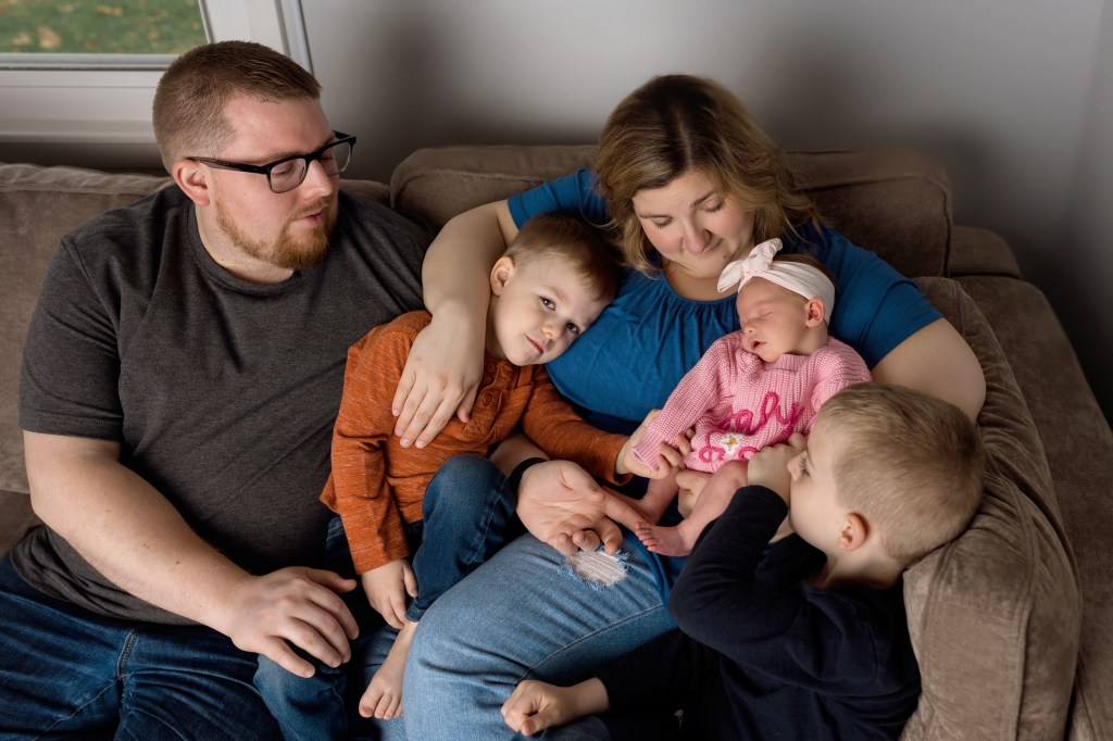 family loving on newborn baby newborn photography