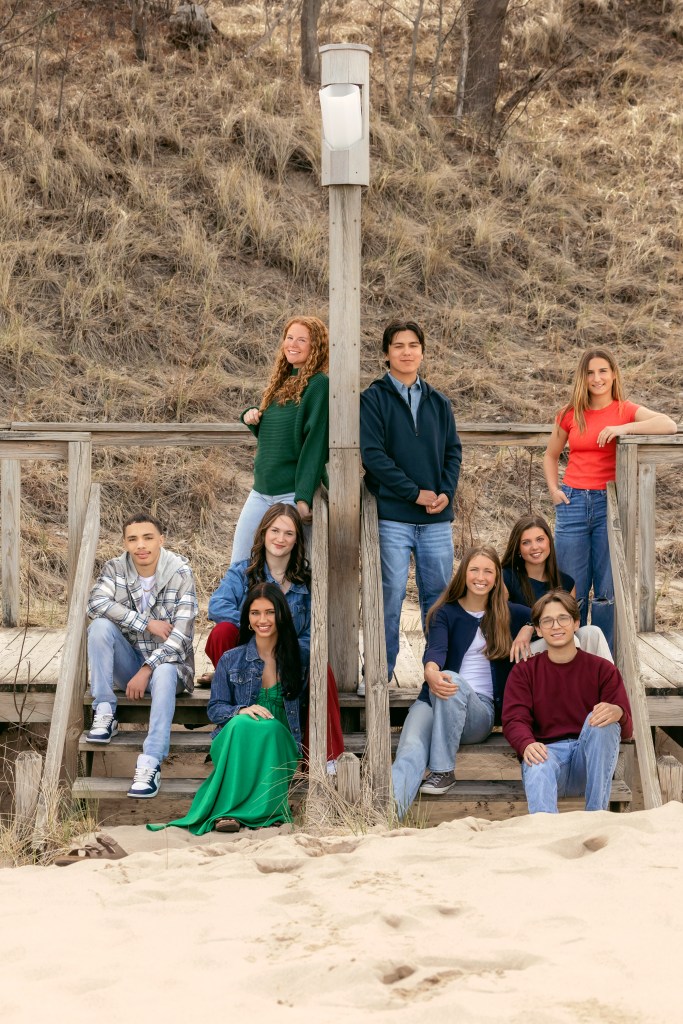 High school senior smiling together during beach senior pictures in Southwest Michigan