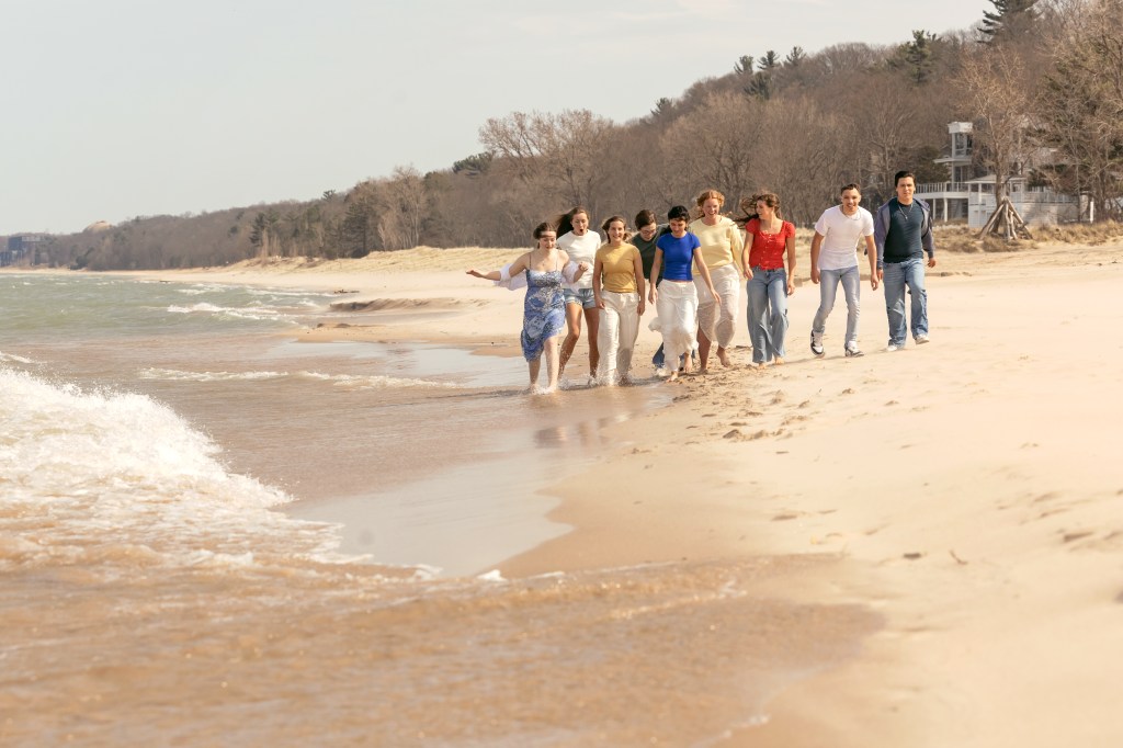 Senior rep team walking along the Lake Michigan shoreline at Weko Beach in Bridgman Michigan