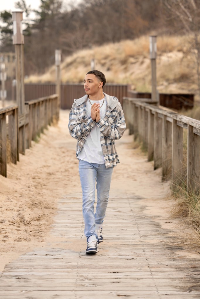 Senior boy portrait on a Lake Michigan beach boardwalk in Bridgman Michigan