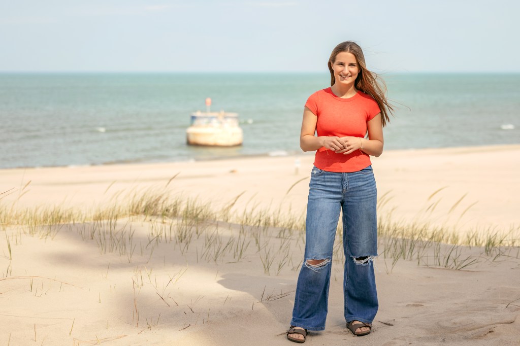 Senior girl posing on the beach at Weko Beach in Southwest Michigan