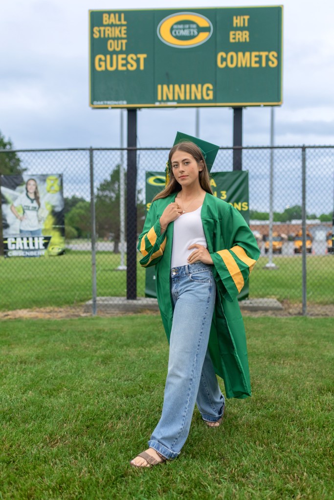 Coloma High School senior athlete cap and gown portrait on varsity softball field