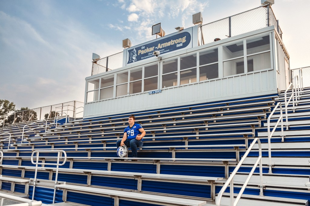 Lawton High School Class of 2027 senior sitting alone in the football stadium bleachers at Lawton High School.