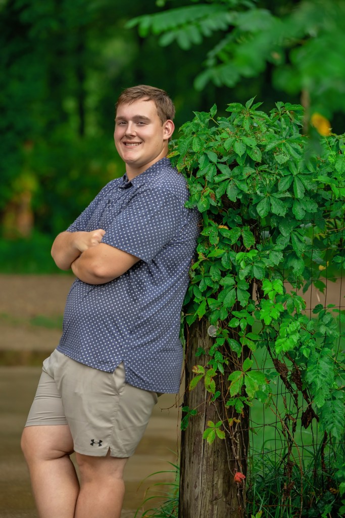 Lawton High School Class of 2027 senior leaning against a tree on his grandfather's property in Southwest Michigan.