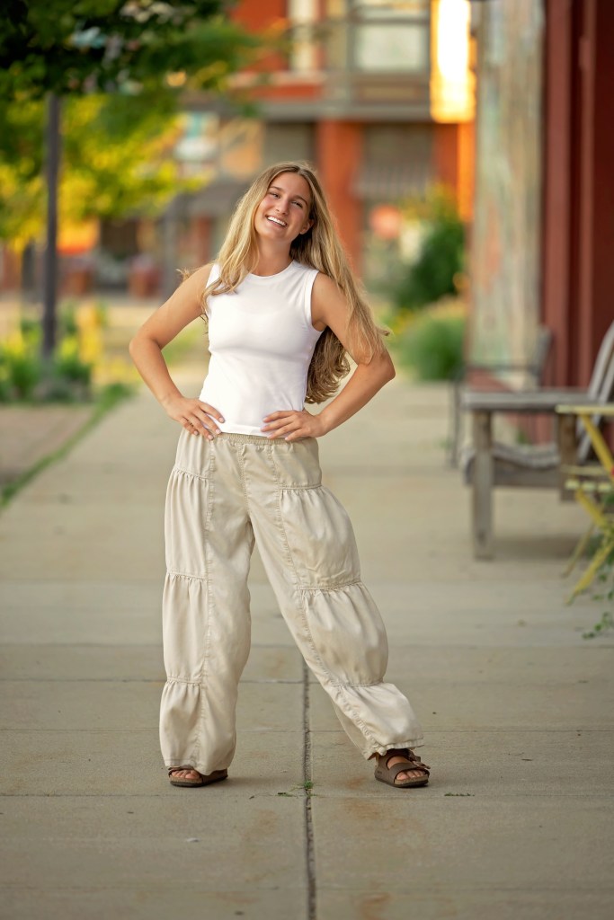 Downtown Benton Harbor senior pictures featuring colorful storefronts and sidewalks.