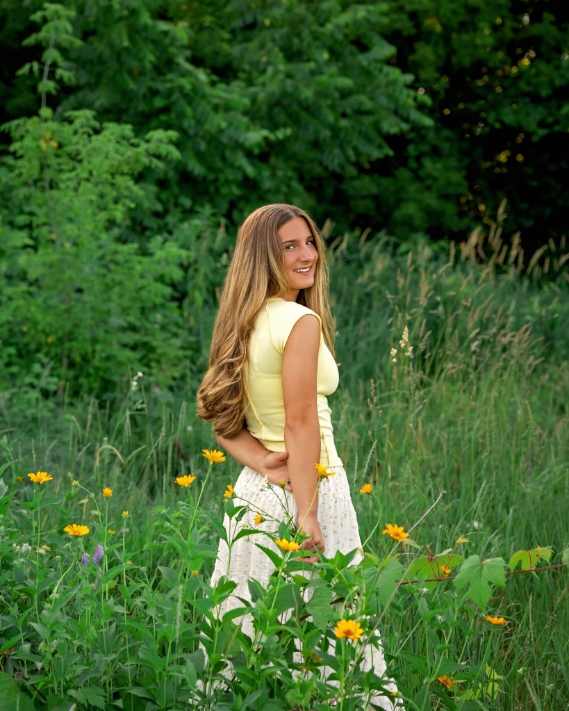 Class of 2027 senior standing in a wildflower field near Benton Harbor, Michigan.