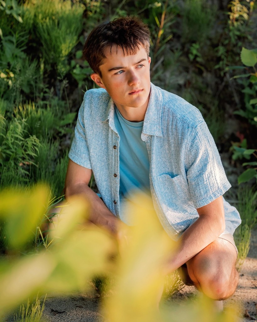 Senior portrait of a St. Joseph High School Class of 2027 student on the sandy shores of Lake Michigan
