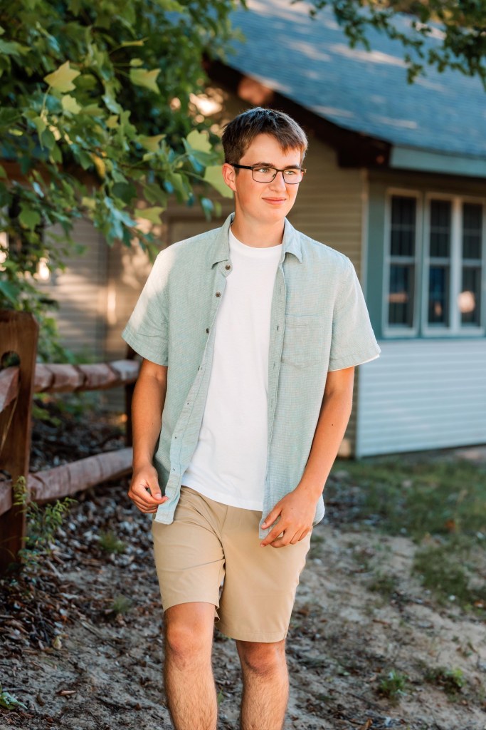 Natural senior portrait of a St. Joseph High School senior in a private lakeside greenspace