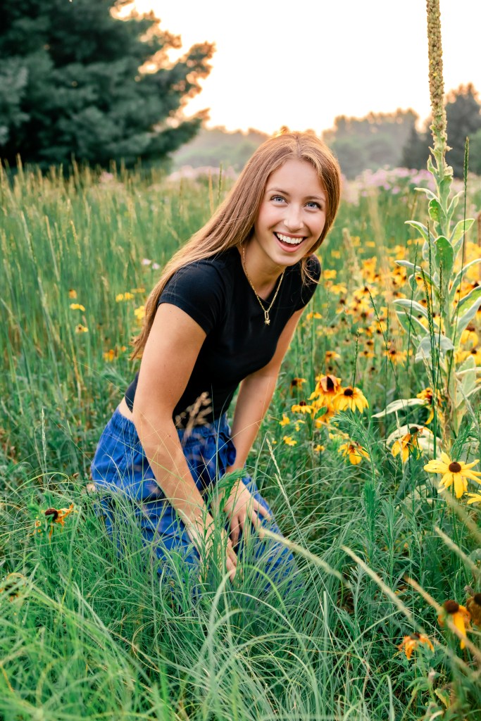 Laughing senior girl in wildflower meadow