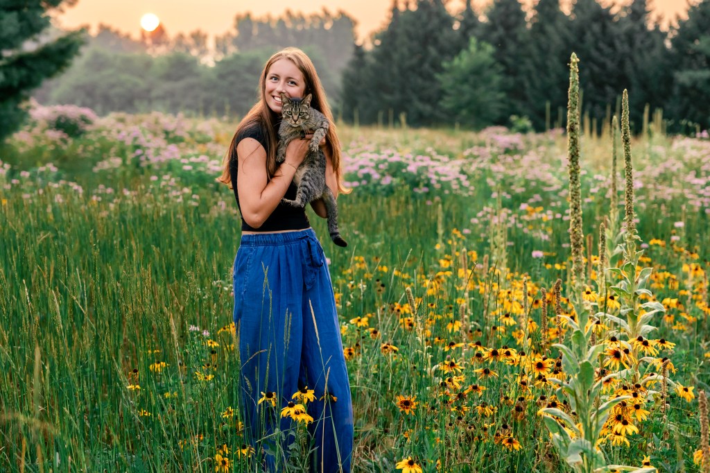 High school senior girl posing with cat class of 2027